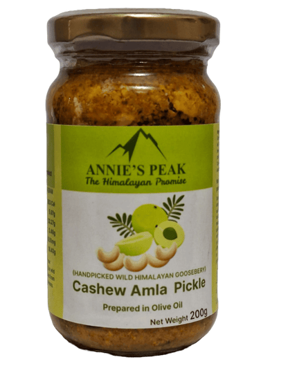 A jar of Cashew Amla Pickle with olive oil, clearly labeled with the brand Annie's Peak and the product name, against a plain background.